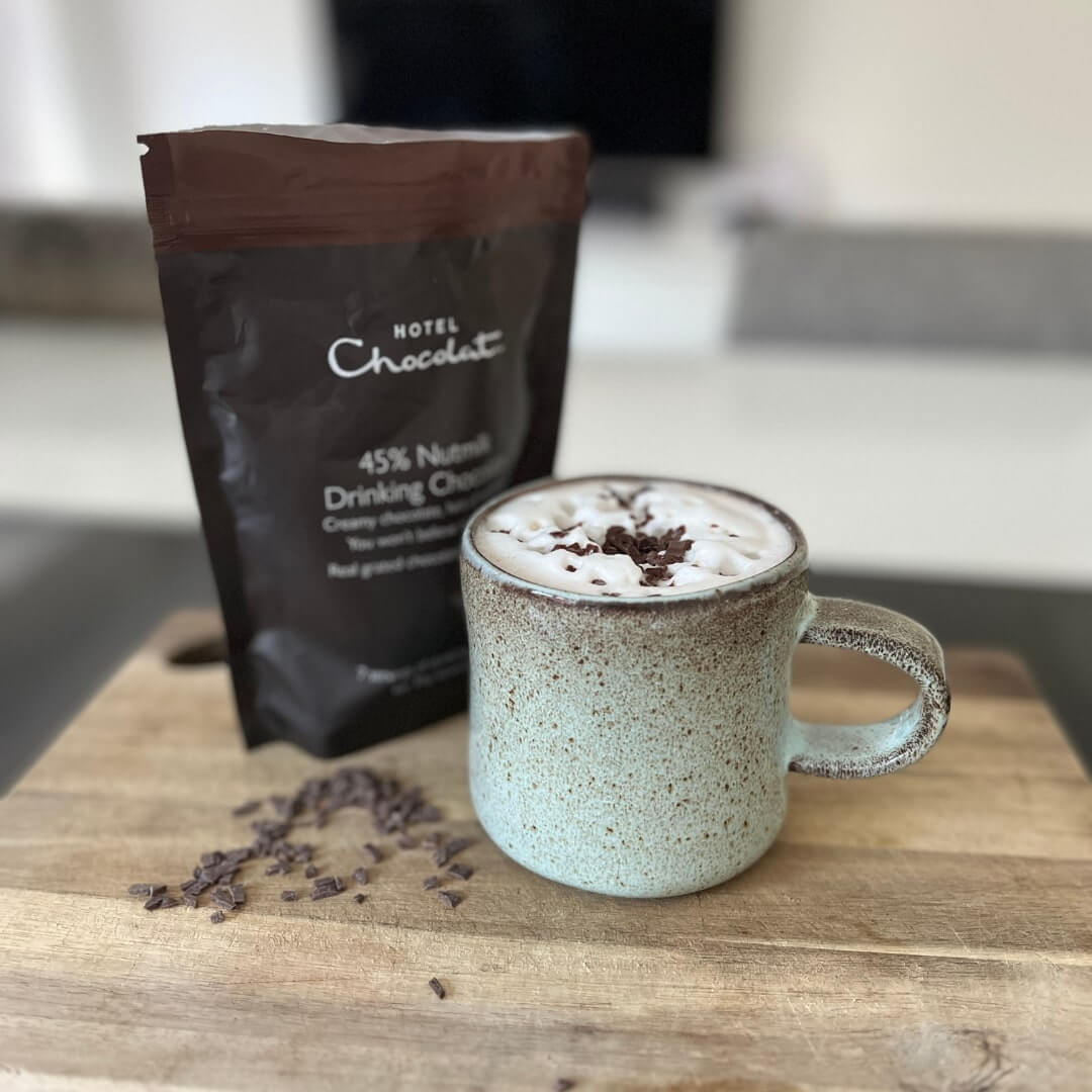 Rock Pool mug containing milk and hazelnut chocolate flakes from Hotel Chocolat